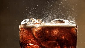 A glass of cola with ice. Splashes on the surface. Filmed on a high-speed camera at 1000 fps. High quality FullHD footage - Powered by Shutterstock - Get 15% off with code: PIKWIZARD15