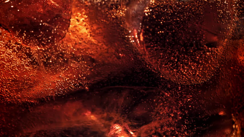 Bubbles in a glass of cola with ice. Filmed on a high-speed camera at 1000 fps. High quality FullHD footage