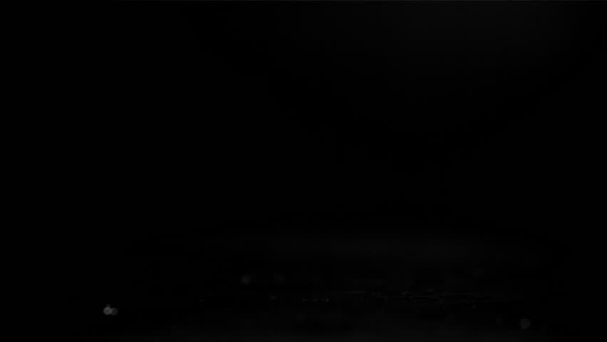 A fresh meat burger falls on a black table. Filmed on a high-speed camera at 1000 fps. High quality FullHD footage