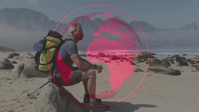 male hiker with pack holding poles, sitting on beach rock displaying data globe overlay for tech. Adventure, exploration, outdoor, wilderness, resilience, digital, technology - Powered by Shutterstock - Get 15% off with code: PIKWIZARD15