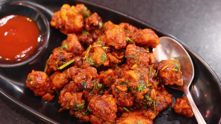 Gobi Manchurian dry Gobi 65 chilly gobi or cauliflower fry. Popular street food of India made of cauliflower florets Mumbai Mysore Karnataka India
