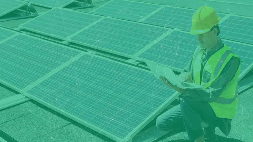 Man kneeling on rooftop solar panels, typing on laptop showing solar technology data network. Renewable energy, technology, innovation, sustainability, engineering, digital network, professional - Powered by Shutterstock - Get 15% off with code: PIKWIZARD15