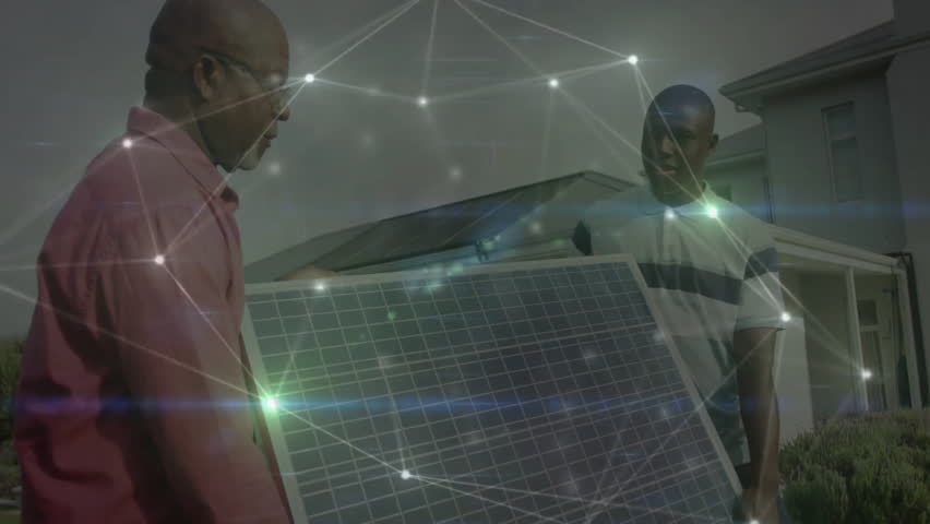 Senior and junior installer carrying solar panel in front yard, showing energy network overlay. Sustainability, renewable, technology, innovation, teamwork, outdoor, modern - Powered by Shutterstock - Get 15% off with code: PIKWIZARD15