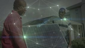 Senior and junior installer carrying solar panel in front yard, showing energy network overlay. Sustainability, renewable, technology, innovation, teamwork, outdoor, modern - Powered by Shutterstock - Get 15% off with code: PIKWIZARD15