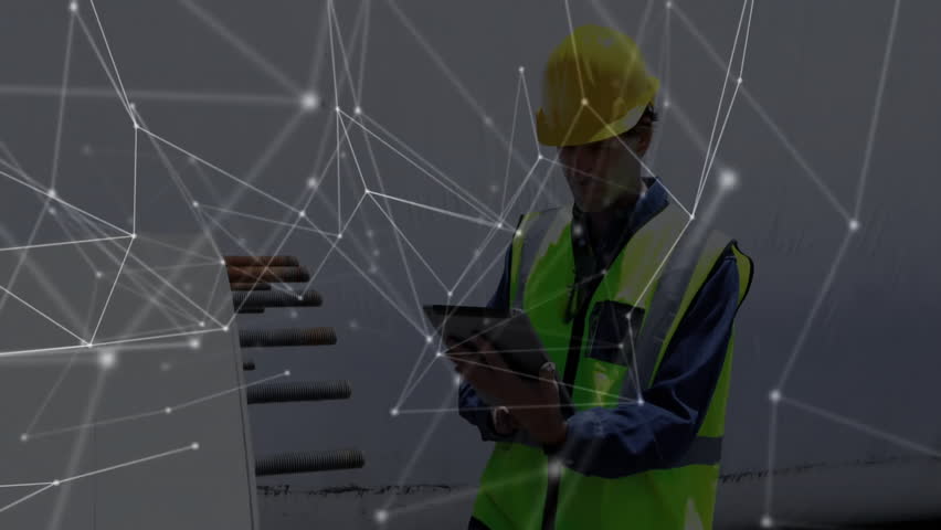 construction worker standing on site wearing yellow helmet, green vest, displaying network overlay. Industries, safety, automation, engineering, infrastructure, technology, industry - Powered by Shutterstock - Get 15% off with code: PIKWIZARD15