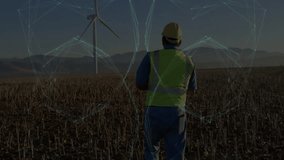 man monitoring agriculture data on farmland, with digital network sphere overlay near wind turbine. Technology, connectivity, rural, innovation, sustainability, resilience, landscape - Powered by Shutterstock - Get 15% off with code: PIKWIZARD15