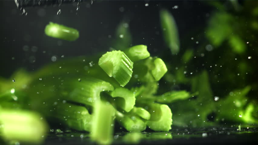 The knife cuts through the fresh sprinkled celery. Filmed on a high-speed camera at 1000 fps. High quality FullHD footage