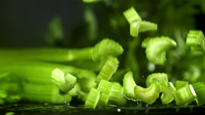 Pieces of chopped celery fall on the table. Filmed on a high-speed camera at 1000 fps. High quality FullHD footage