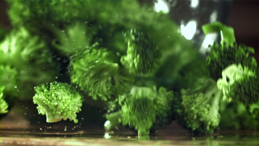 Dropping broccoli with splashing water. Filmed on a high-speed camera at 1000 fps. High quality FullHD footage