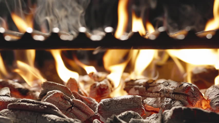 Traditional barbecue comes to life with burning coals that create cooking surface. Bright red hue of coal contrasts with dark background, filling air with characteristic aroma of smoldering coal. AD