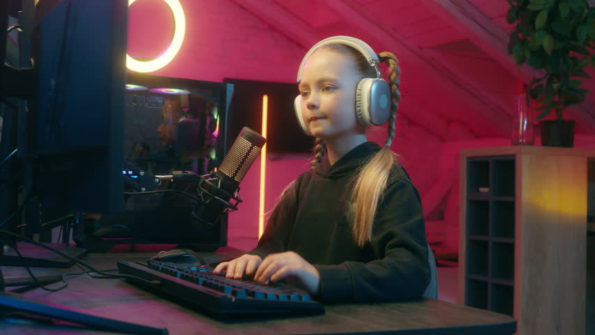 Emotional little girl gamer difficult hard streaming typing keyboard lost failure daughter kid child teen playing computer virtual video game at home upset take off headphones sad suffer disappointed