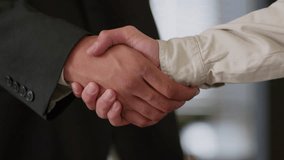 Close up African male hands handshaking in company corporate office shake arms shaking unity cooperation partnership two colleagues males guys men business deal businessmen hiring insurance bank loan - Powered by Shutterstock - Get 15% off with code: PIKWIZARD15