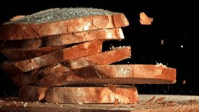 Sliced bread falls onto a cutting board. Filmed on a high-speed camera at 1000 fps. High quality FullHD footage - Powered by Shutterstock - Get 15% off with code: PIKWIZARD15