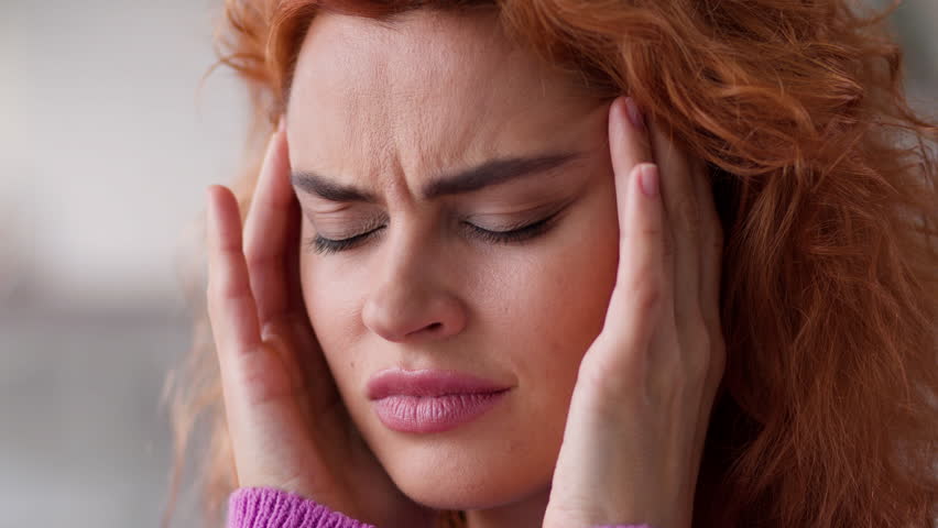 Close up portrait at home sad woman girl lady female wife indoors apartment bad feeling unhealthy headache pain head migraine ache pressure health problem trouble medicine painkiller ill sick fever