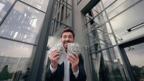 Moving shot happy rich wealthy Caucasian businessman in city looking in camera holding cash money dollars prize financial winning excited yelling celebrate finance bet success business man male guy - Powered by Shutterstock - Get 15% off with code: PIKWIZARD15