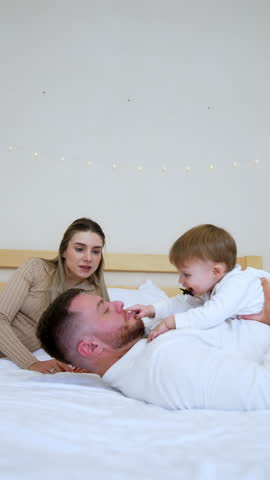 Lovely baby boy lying on the dad