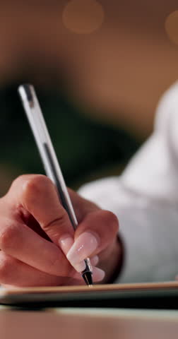 Person, hands and writing with pen for diary notes, schedule planning or reminder on desk. Closeup, journalist or copywriter with words, journal or author for literature, letter or private invitation