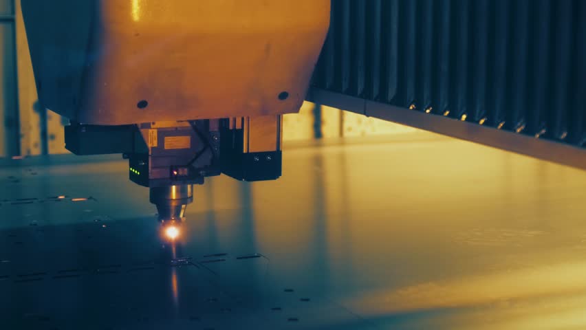 Close-Up of CNC Laser Cutting Head Operating on Metal Plate