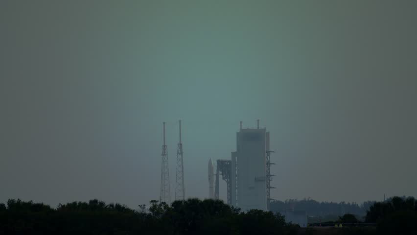 A powerful rocket blasts off from the launch pad at dusk to send communications satellites into space and earth orbit. With Audio.