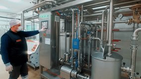 Operator Controlling Automated Milk Processing System via Touchscreen Panel - Powered by Shutterstock - Get 15% off with code: PIKWIZARD15