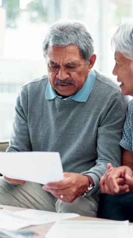 Senior couple, documents and confused in home with taxes, income and pension funding for retirement. Elderly man, woman and paperwork for money, investment and financial compliance in living room