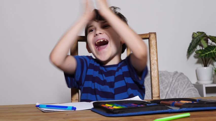 Boy is studing at home, doing homework