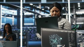 Data center computer scientists use node tree programming to identify equipment performance issues. Server farm employees review data analysis graphs to minimize infrastructure failures, camera B - Powered by Shutterstock - Get 15% off with code: PIKWIZARD15