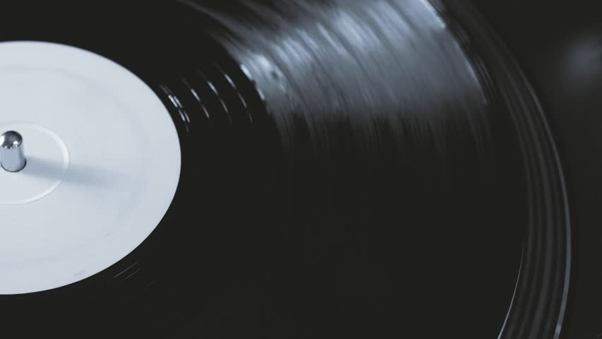 DJ headshell on spinning turntable. Listening the music on vinyl. Closeup