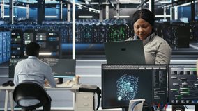 Annoyed data center admin having trouble doing node tree programming. Irked woman in server room having glitching issues while using predictive AI visualization systems on notebook, camera A - Powered by Shutterstock - Get 15% off with code: PIKWIZARD15