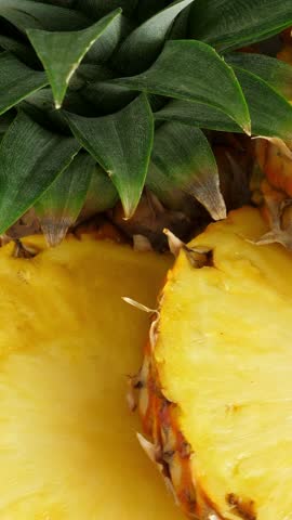 Sliced pineapple fruit. rotating. Vertical footage