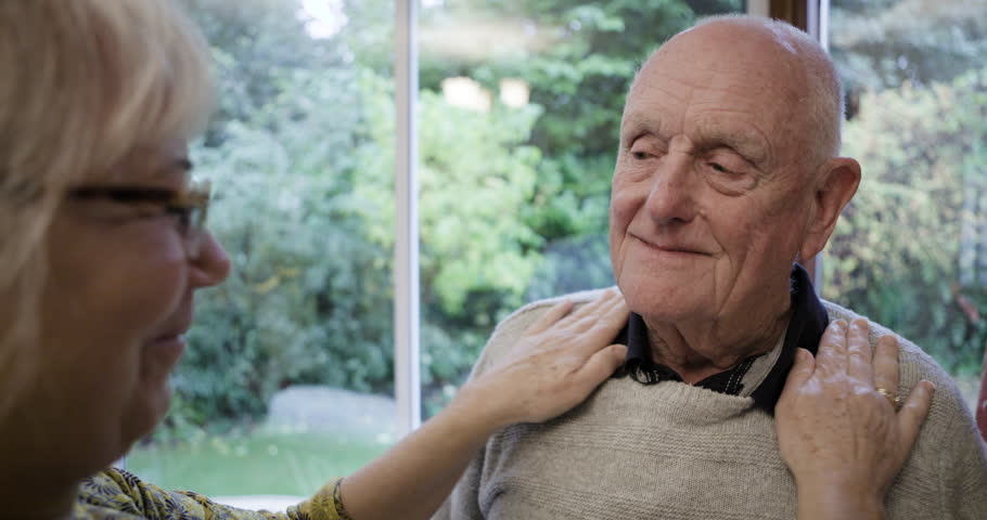 Love, home and woman dressing her husband for an event, work or a romantic date together. Happy, care and loving elderly wife helping her senior man in retirement while getting ready at their house.