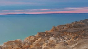 Serene Coastal Cliffs at Sunset, Pastel Hues, Calm Ocean - Powered by Shutterstock - Get 15% off with code: PIKWIZARD15
