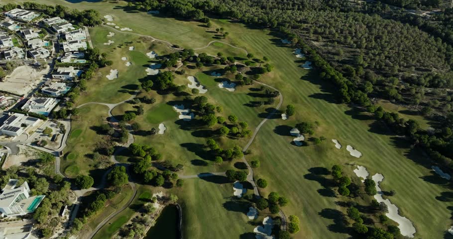 Drone shot of a luxury golf course and premium real estate near Almería, Spain. Scenic greens, modern villas, and Mediterranean coastal vibes.