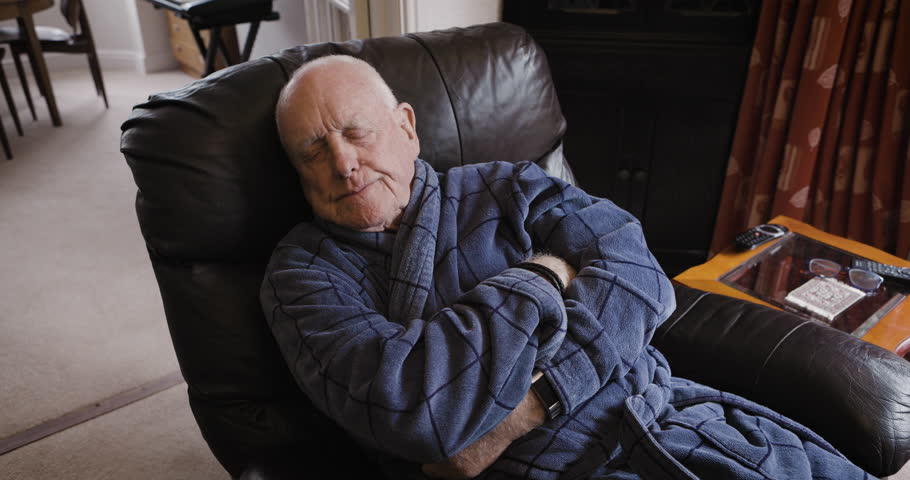 Senior man, sofa and sleeping in living room, resting or nap after rehabilitation in home. Relax, chair and retired, elderly and cold male from Canada in lounge tired after physiotherapy session.