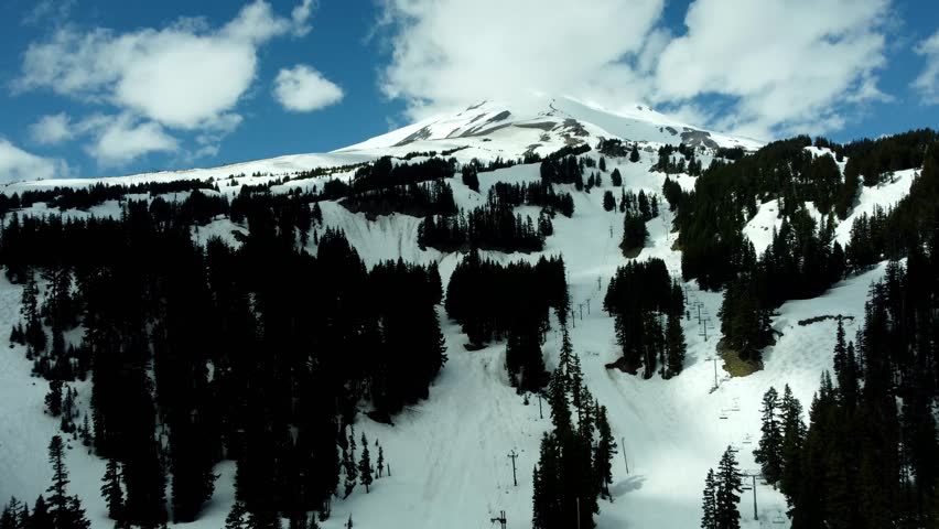 US, Oregon, Mt Hood, Meadows Ski Area, 2025-04-22 - Drone view of Mt Hood at the Mt Hood Meadows ski area in spring. Flying up the ski runs and lifts.