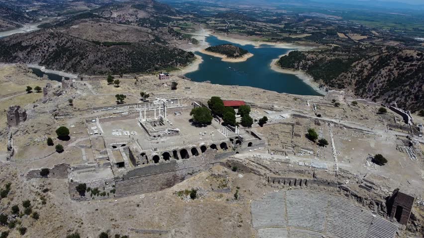 Aerial: Pergamon Acropolis with Ancient Temple remains during the day in Bergama, Turkey, orbit drone shot