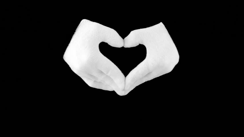 Black background. Hands in white gloves represent the beating heart