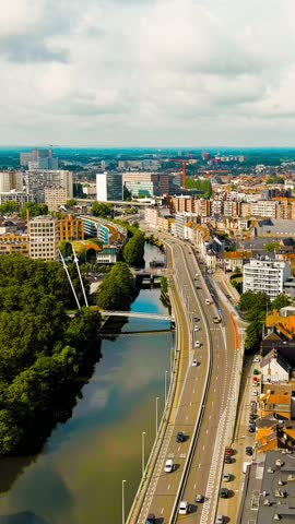 Vertical video. Ghent, Belgium. Esco (Scheldt) river embankment. Panorama of the city from the air. Cloudy weather, summer day, Aerial View. Rich colors
