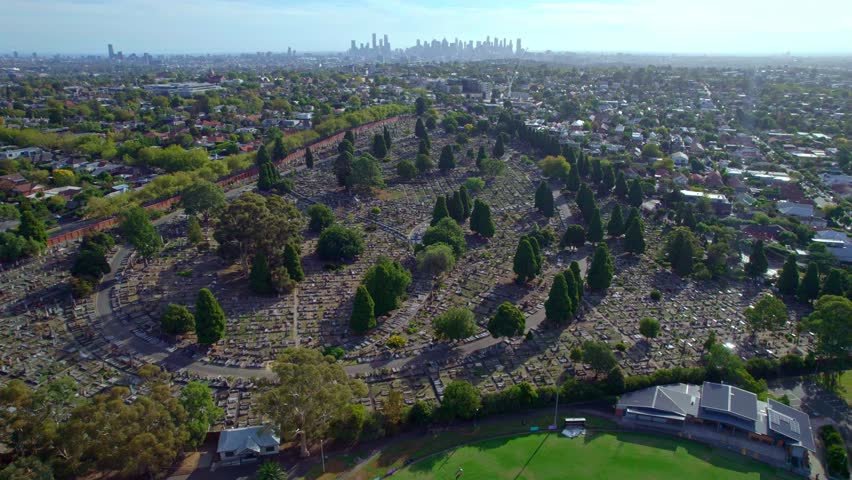 Aerial view over the Boroondara General Cemetery, with the Melborne city skyline in the background, Victoria, Australia. March 2025.