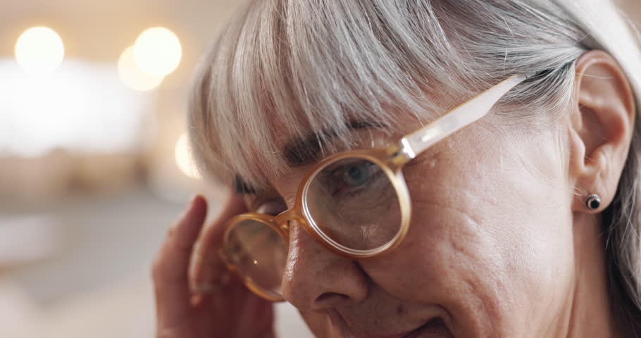 Senior, woman and stress with headache in home for retirement debt, financial crisis and overwhelmed. Bokeh, elderly person and migraine with mistake, pressure and unhappy for decision and anxiety