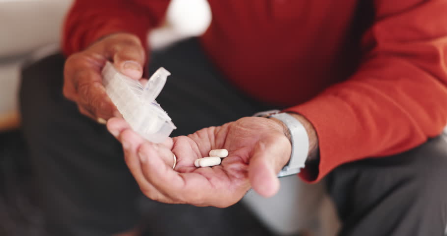 Senior, hands or pill container in retirement for prescription medication, daily treatment or health benefits. Healthcare, old man or drugs for wellness supplements, arthritis or medical cure in home