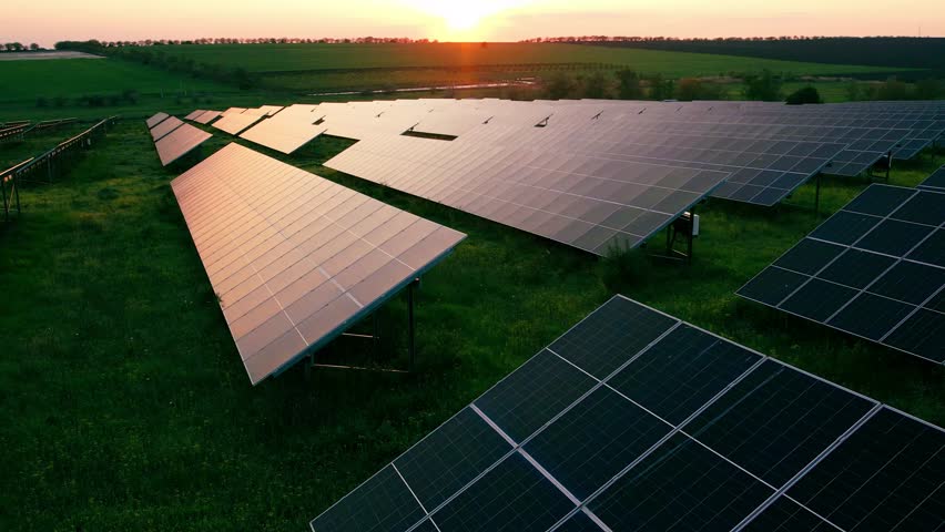 Solar panels park generating green energy electric at sunset.Green energy reduce carbon emissions and makes earth cleaner and more ecological.Alternative power source to saving environment.	
