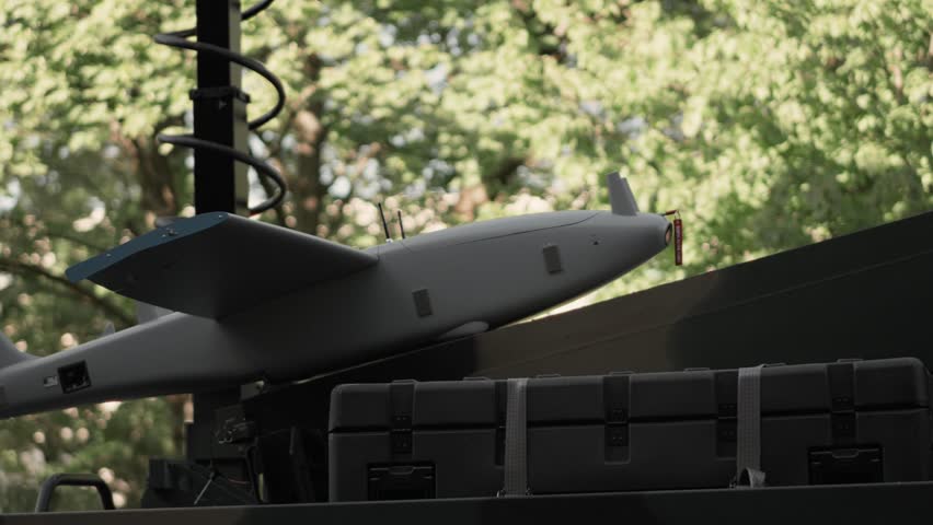 Detailed view of a tactical reconnaissance UAV drone designed for deep battlefield surveillance and target acquisition, stationed on a military platform.