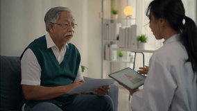 Elderly Asian man having health consultation with female doctor at home. Discussing nutrition chart using tablet and document. - Powered by Shutterstock - Get 15% off with code: PIKWIZARD15
