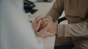 Close-up of an Asian female doctor gently holding hands of an elderly male patient, showing empathy and emotional support during a medical consultation. - Powered by Shutterstock - Get 15% off with code: PIKWIZARD15
