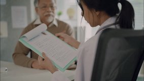 Asian female doctor showing and explaining a patient’s medical history form to a senior man during a healthcare consultation in a modern clinic. - Powered by Shutterstock - Get 15% off with code: PIKWIZARD15