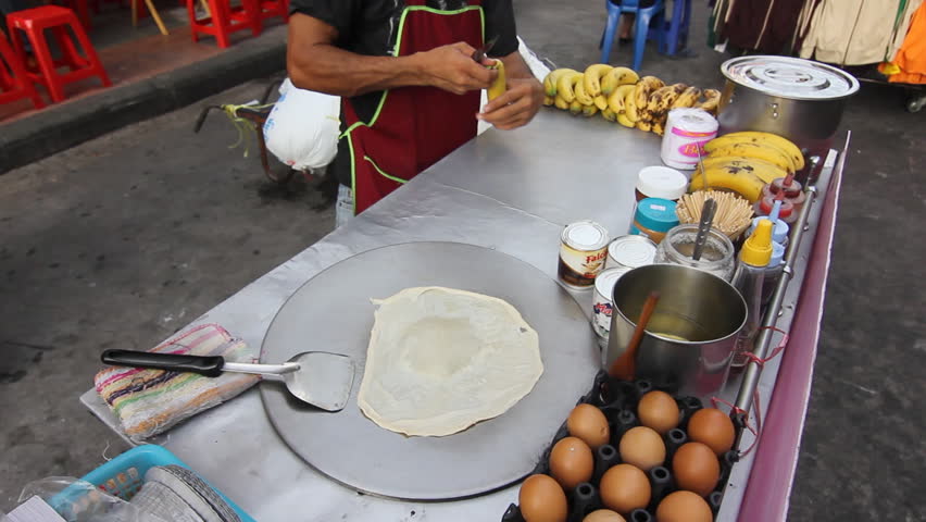 Timelapse of street vendor making a banana crepe
