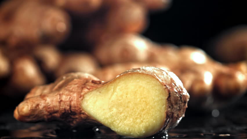 A knife cuts through fresh ginger. Filmed on a high-speed camera at 1000 fps. High quality FullHD footage