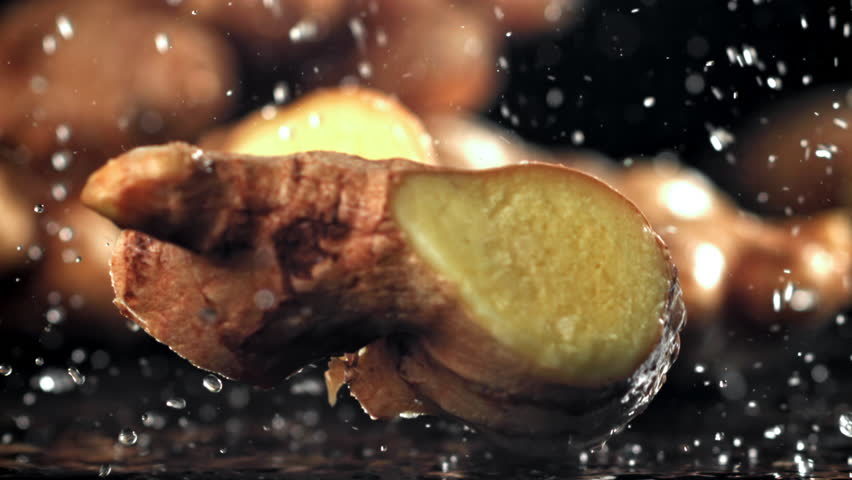 A knife cuts through fresh ginger. Filmed on a high-speed camera at 1000 fps. High quality FullHD footage