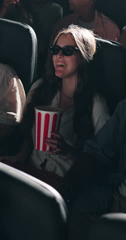 3d glasses, movie and couple laugh in cinema audience with popcorn for modern entertainment. Theatre, interracial people and happy for show, comedy and watching with augmented vision and illusion